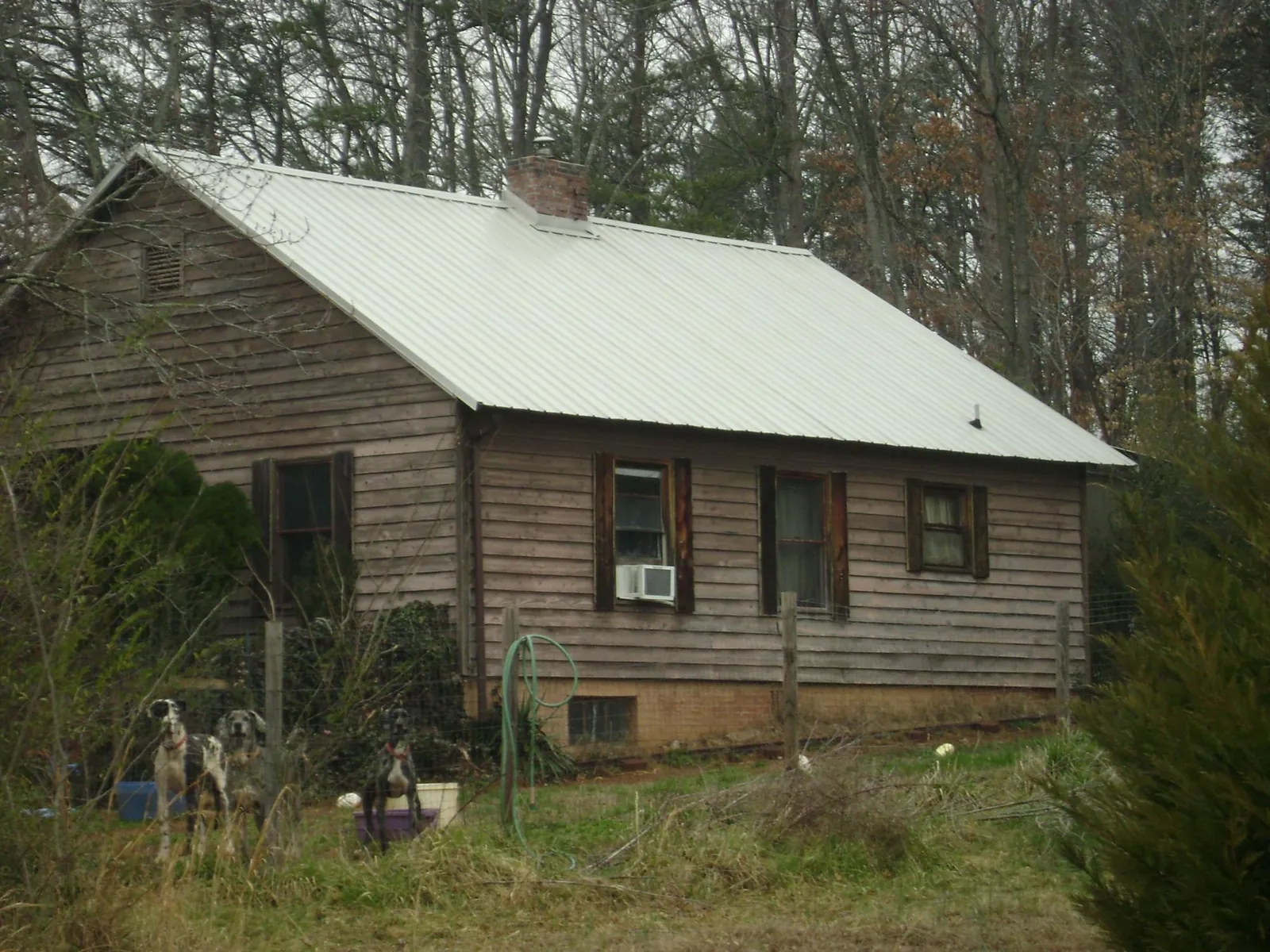 White metal roof on an old wood sided farmhouse, from a Metal Roof Installation job in Acton